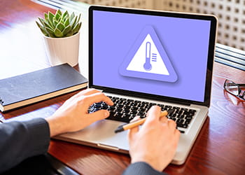 Avoid using the laptop on soft surfaces like beds or couches as they can block the vents and hinder airflow.
Place the laptop on a hard, flat surface like a desk or table.
